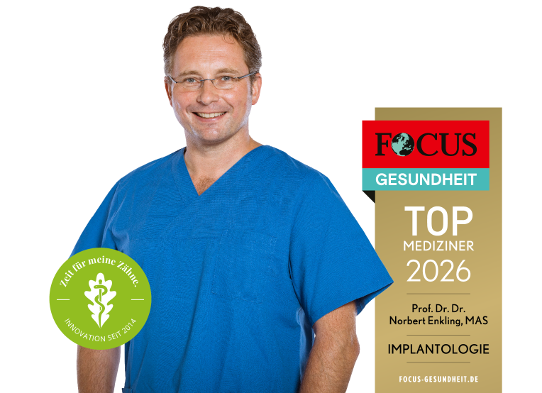 Ein lächelnder Mann in blauer Arztkleidung steht neben einem Focus Gesundheit Siegel für herausragende Implantologie.